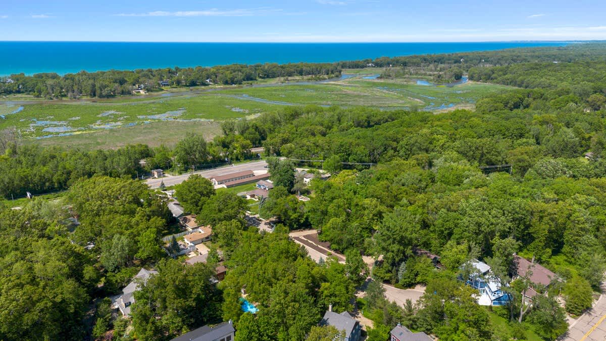 This aerial view captures the beauty of a home surrounded by lush greenery.