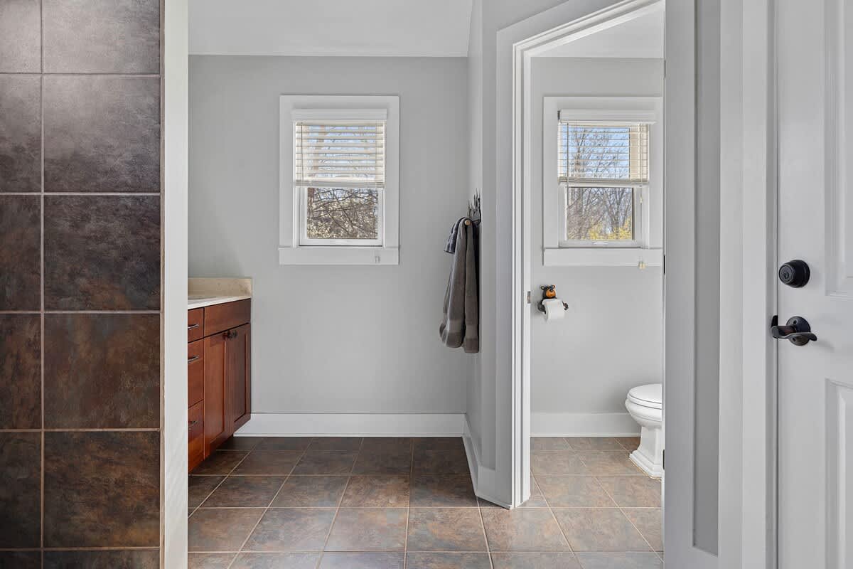 Loving this bathroom's appealing use of tile and its stone-top vanity cabinet.