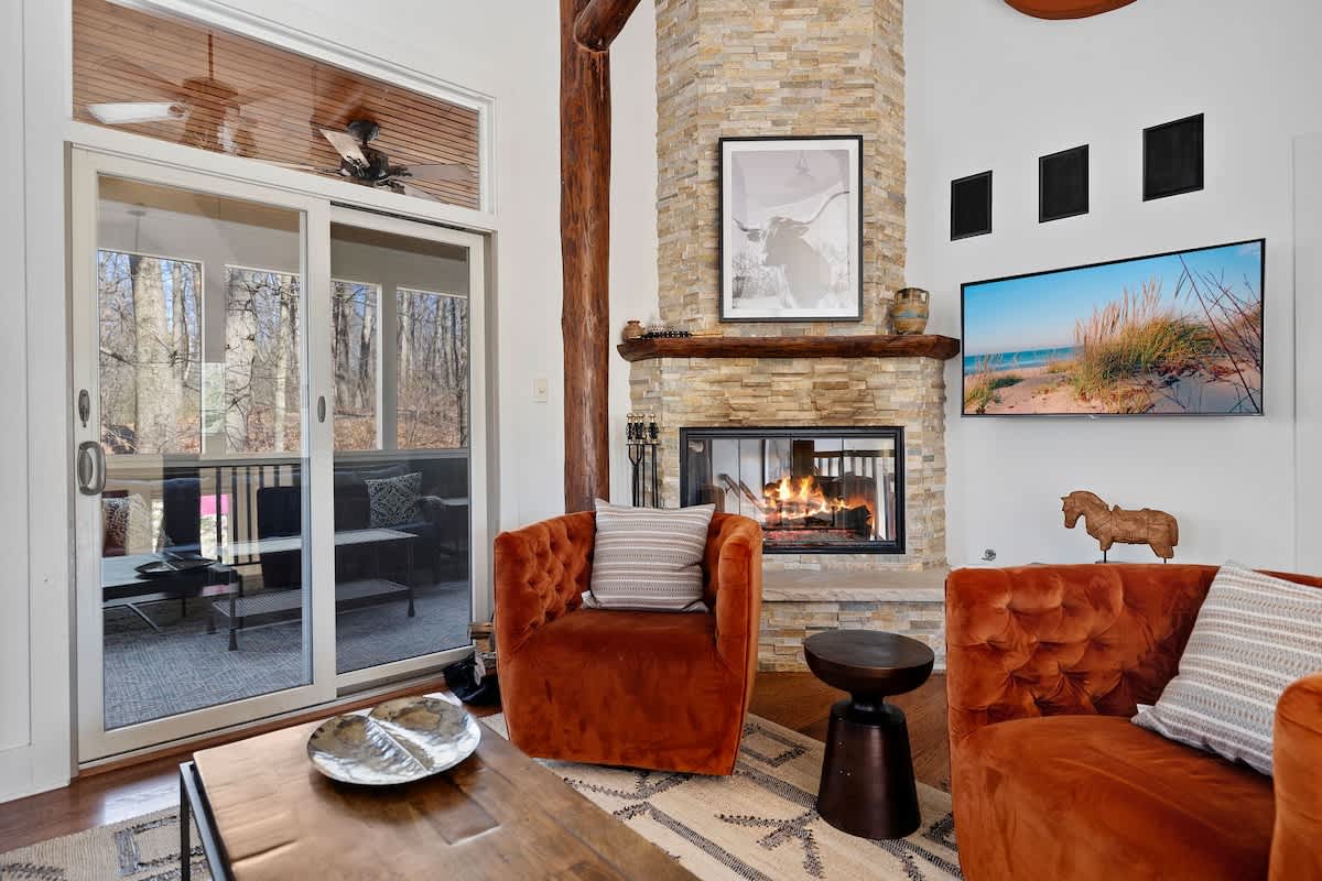 A grand floor-to-ceiling stone fireplace anchors the living room & is a perfect backdrop for family gatherings.