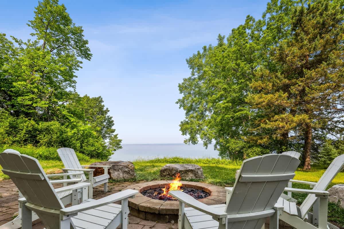 Gather with friends and family around the sandstone patio & firepit overlooking Lake Michigan.