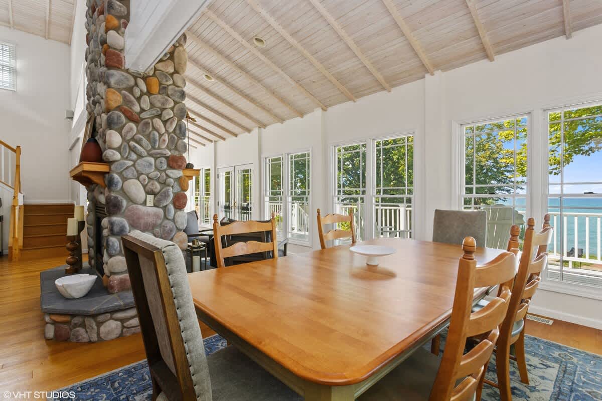 Furnished “upscale cozy” throughout, the spacious living room is drenched in light.