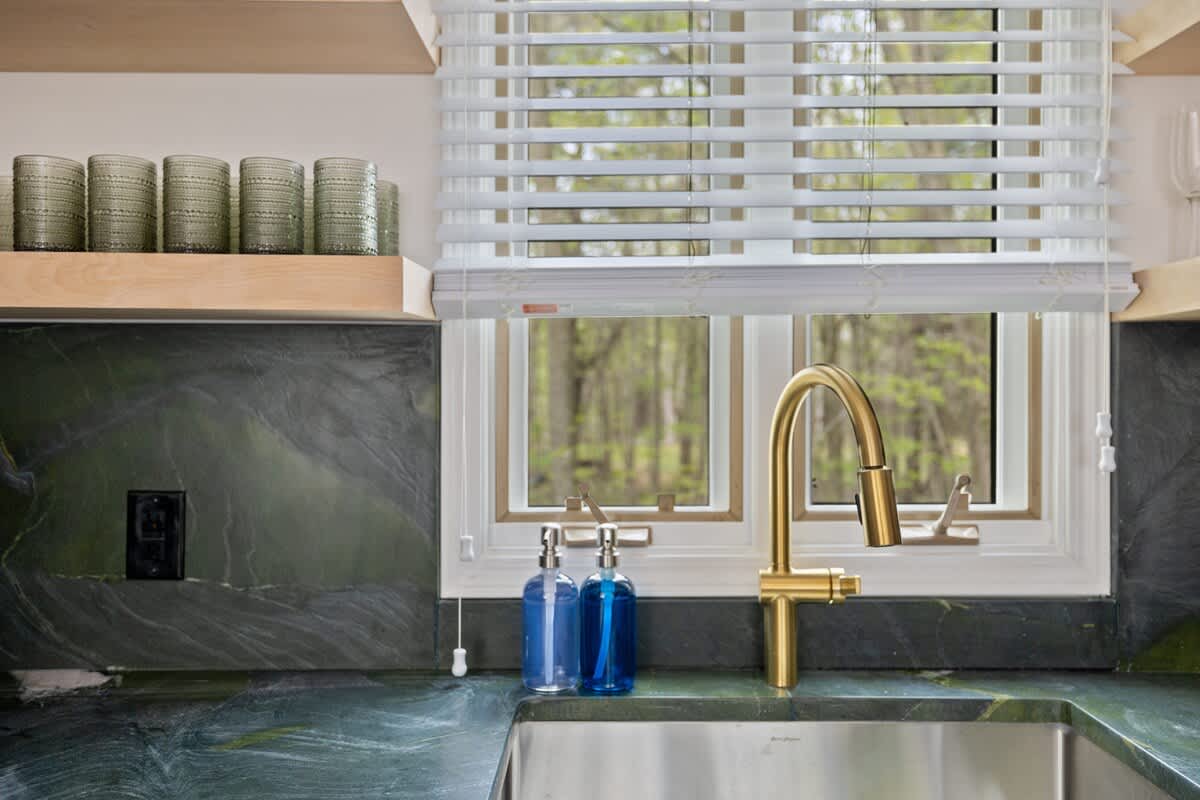 Create delicious meals in our modern kitchen with gorgeous black-and-green quartzite counters.