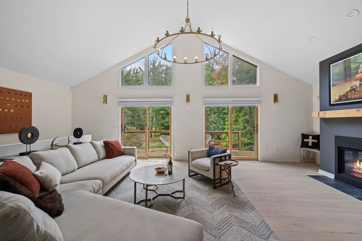 The living room looks out onto a large wooden deck, which affords beautiful sunsets.