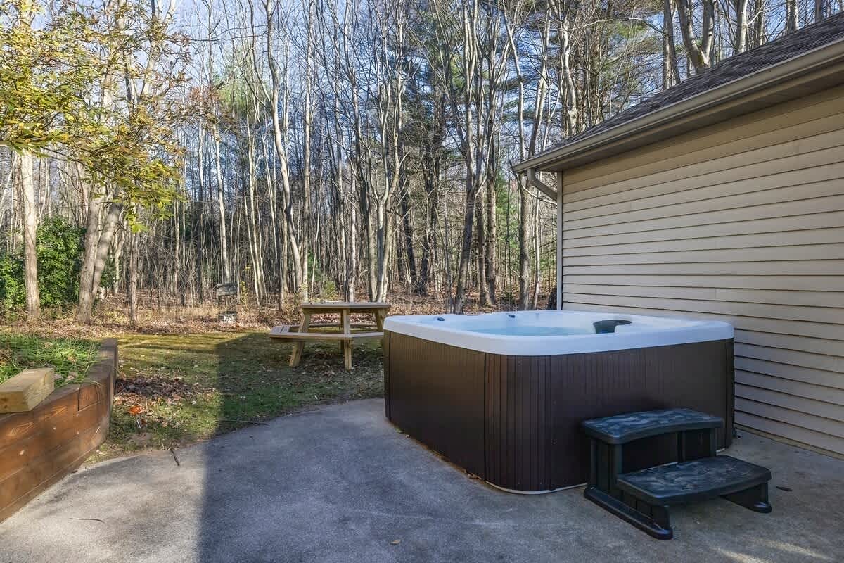 Lounge in the hot tub and take in serene woodland scenery.
