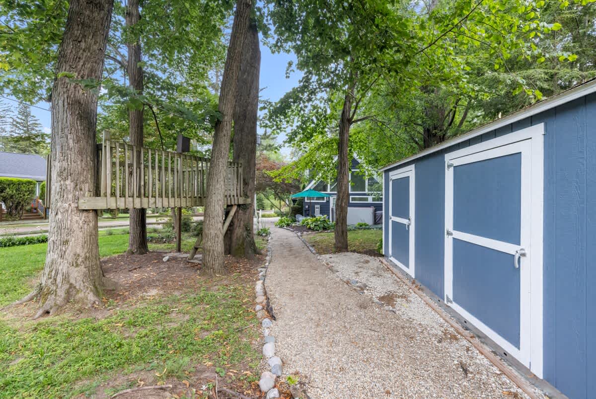 Whimsical treehouse fun along your private garden path.