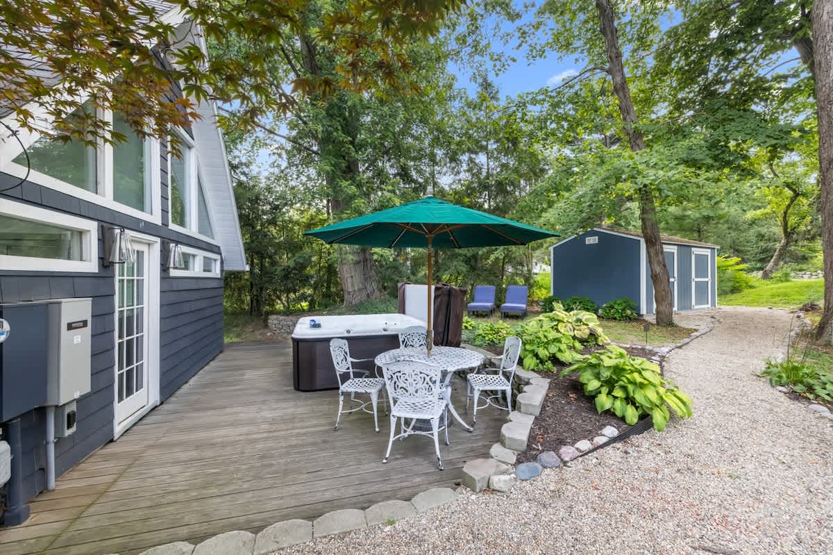 Serene deck escape with spa and shaded seating.
