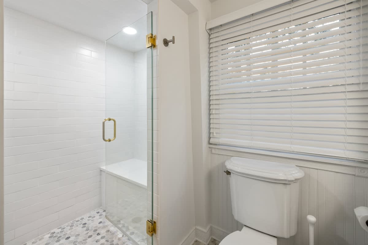 Bright, modern bathroom with glass shower and chic finishes.