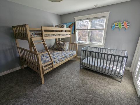 Bedroom 3 is on the main level & has a single-over-full bunkbed and a crib.
