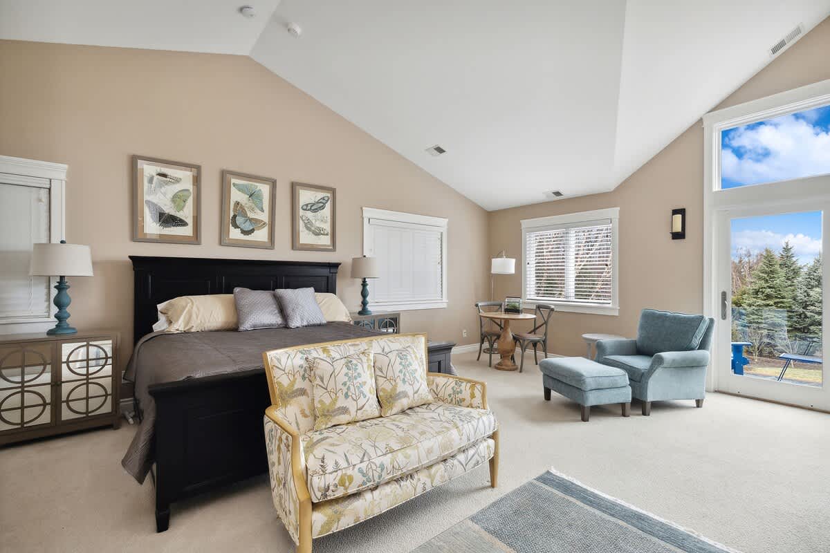 Primary bedroom is on the upper level & has a king-size bed.