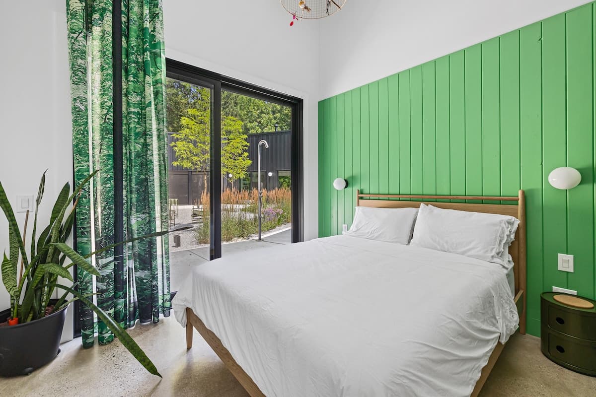 Bedroom 1 has a queen-size bed & courtyard access.