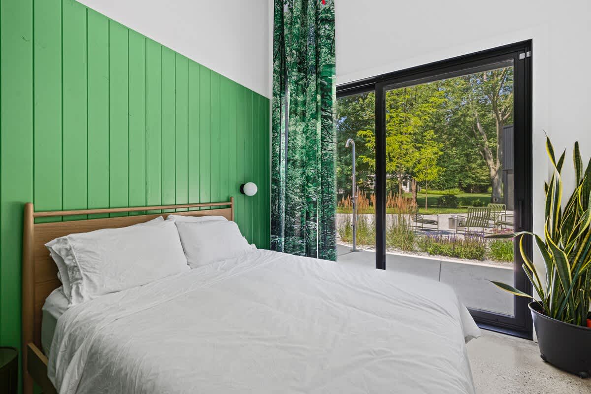 Bedroom 2 has a queen-size bed and courtyard access.