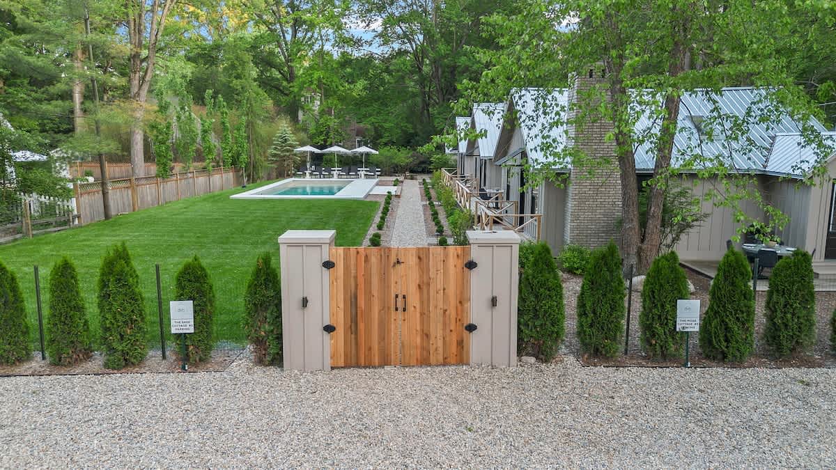 Experience the ultimate in outdoor living with this exquisite house, boasting a sparkling pool and a manicured lawn.