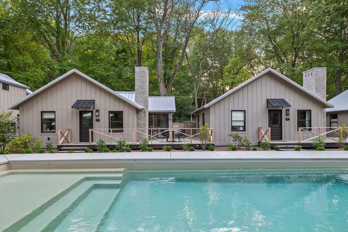 Embracing the beauty of nature at the Townie's cottage with its charming pool and cozy cabins.