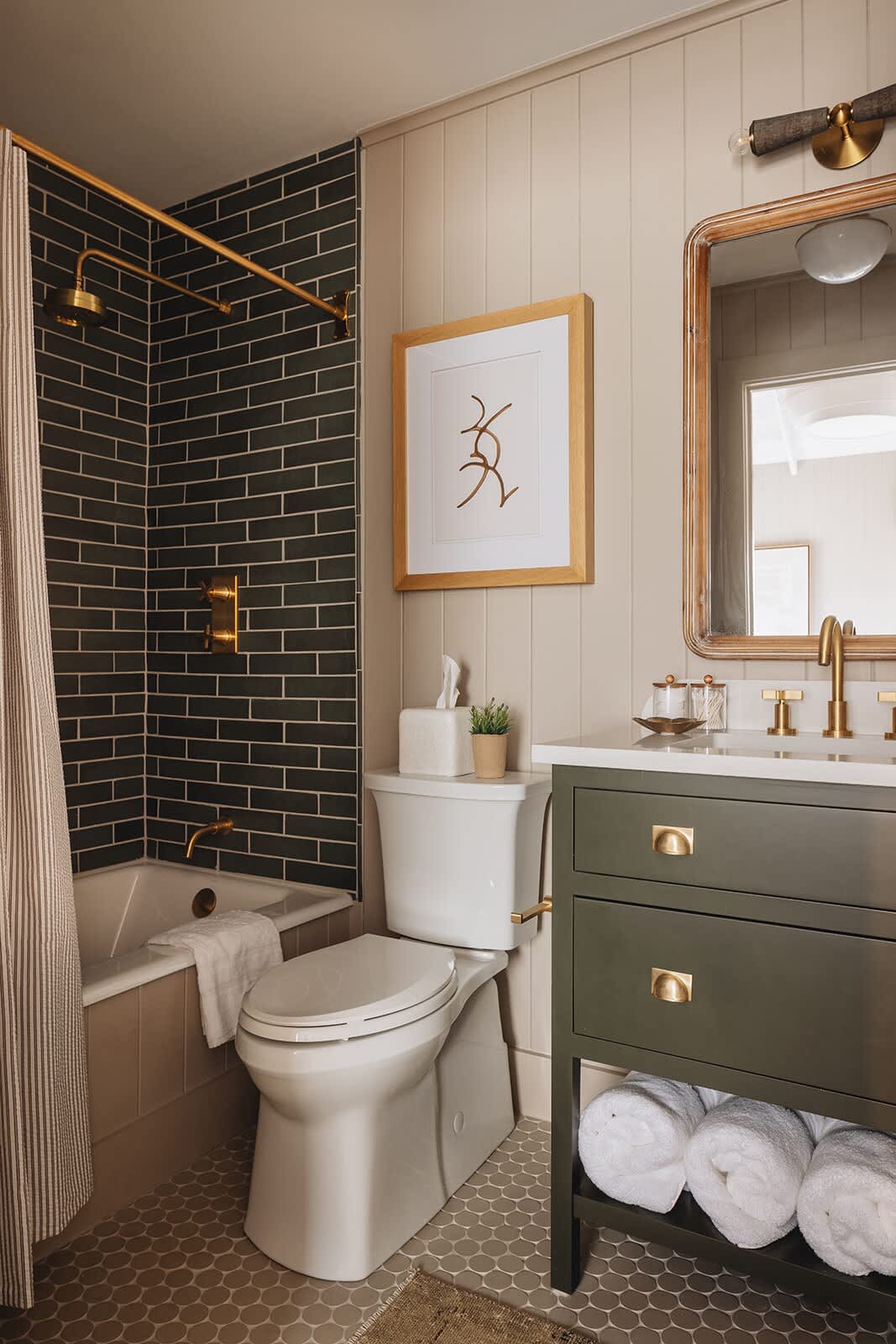 This bathroom has a chic vanity sink and a soaking tub with a Rain Shower head.
