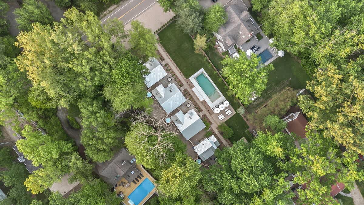 This aerial shot showcases a beautiful home with a pool that’s calling for summer days and pool parties.