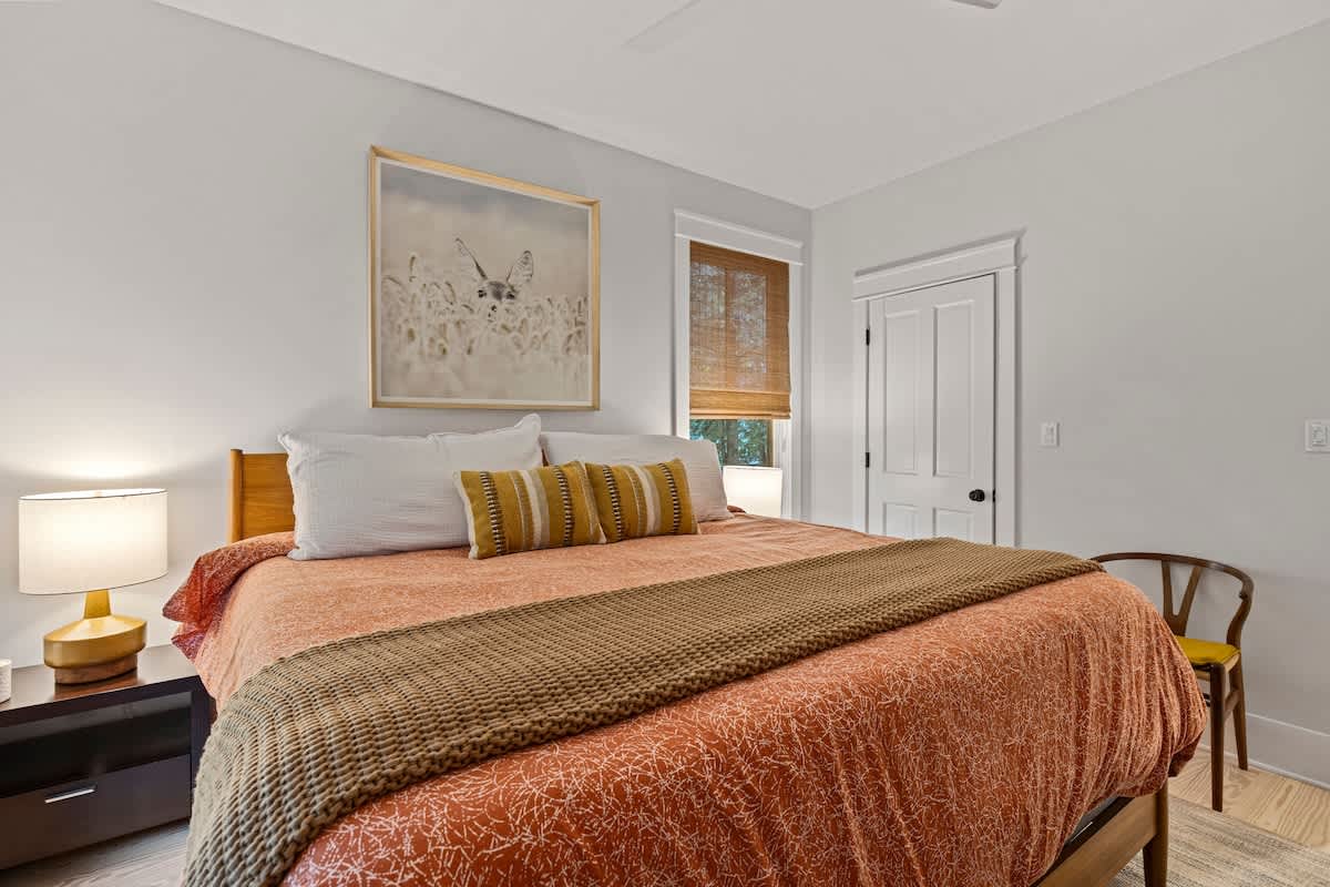 The primary bedroom is on the main level & has a king-sized bed.