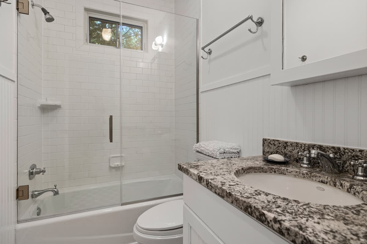 Our full bath features a granite-topped sink and tiled shower.