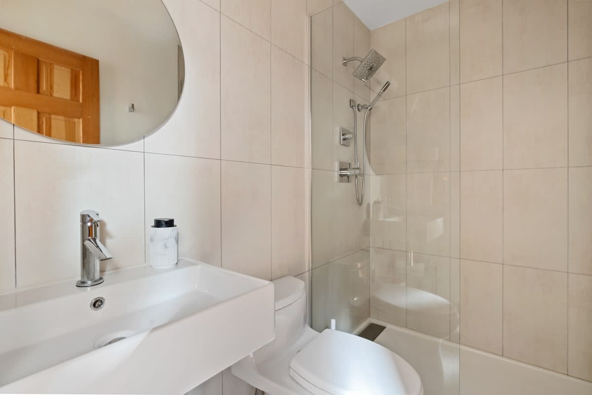 The third full bath is downstairs and shared by bedrooms 2 and 3.