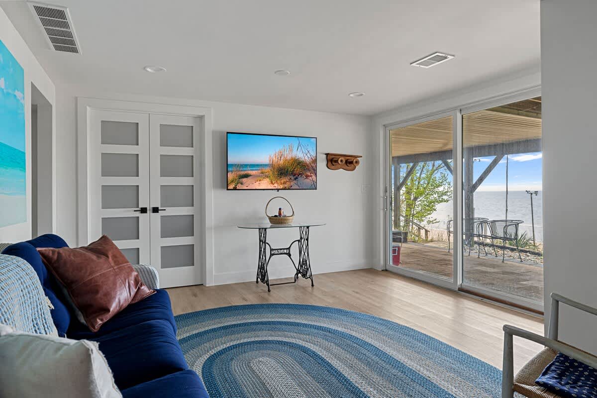 The downstairs family room has plenty of space, cozy seating + a flat-screen TV.