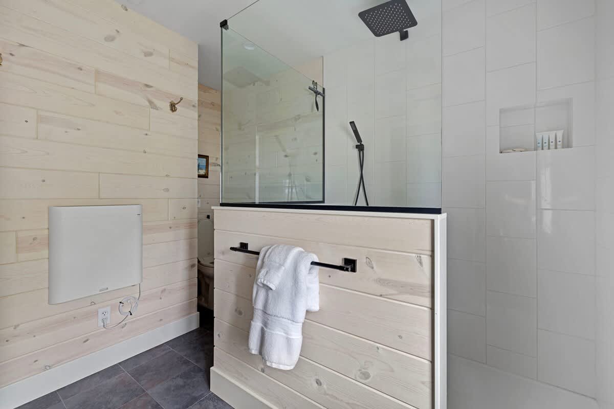 A super-stylish bathroom featuring large walk-in tiled shower and deluxe vanity.