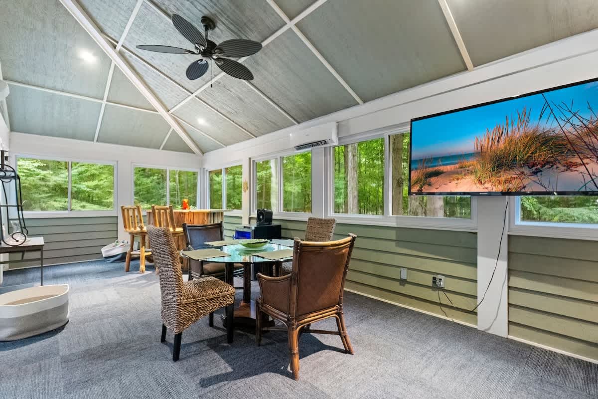 A 3-Seasons Room with all sorts of cool stuff - a custom wood-log bar included.