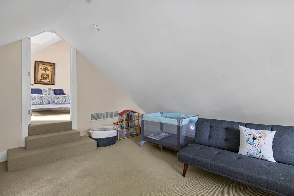 A family room with toys and a crib for guests with kids. Yeah, we've got that.