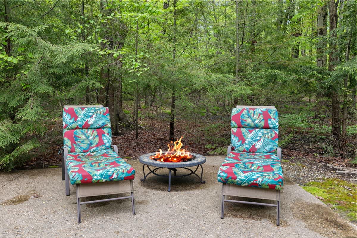 Reclining in stylish and comfy chaise lounges alongside a firepit. Life is good.