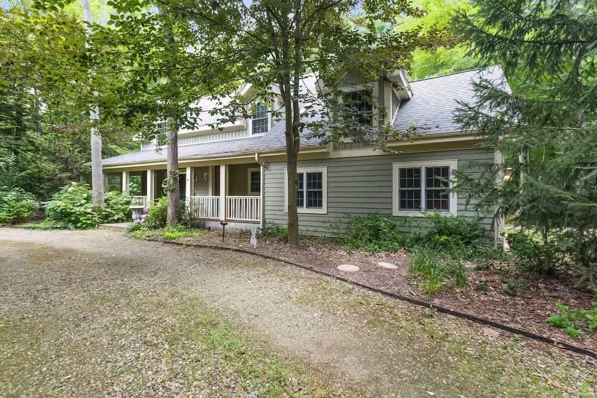 Storybook curb appeal in a peaceful wooded setting.