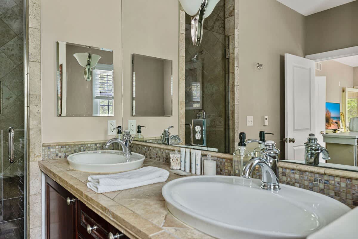 Guests absolutely love the exquisite tiled walk-in shower + dual sink vanities.