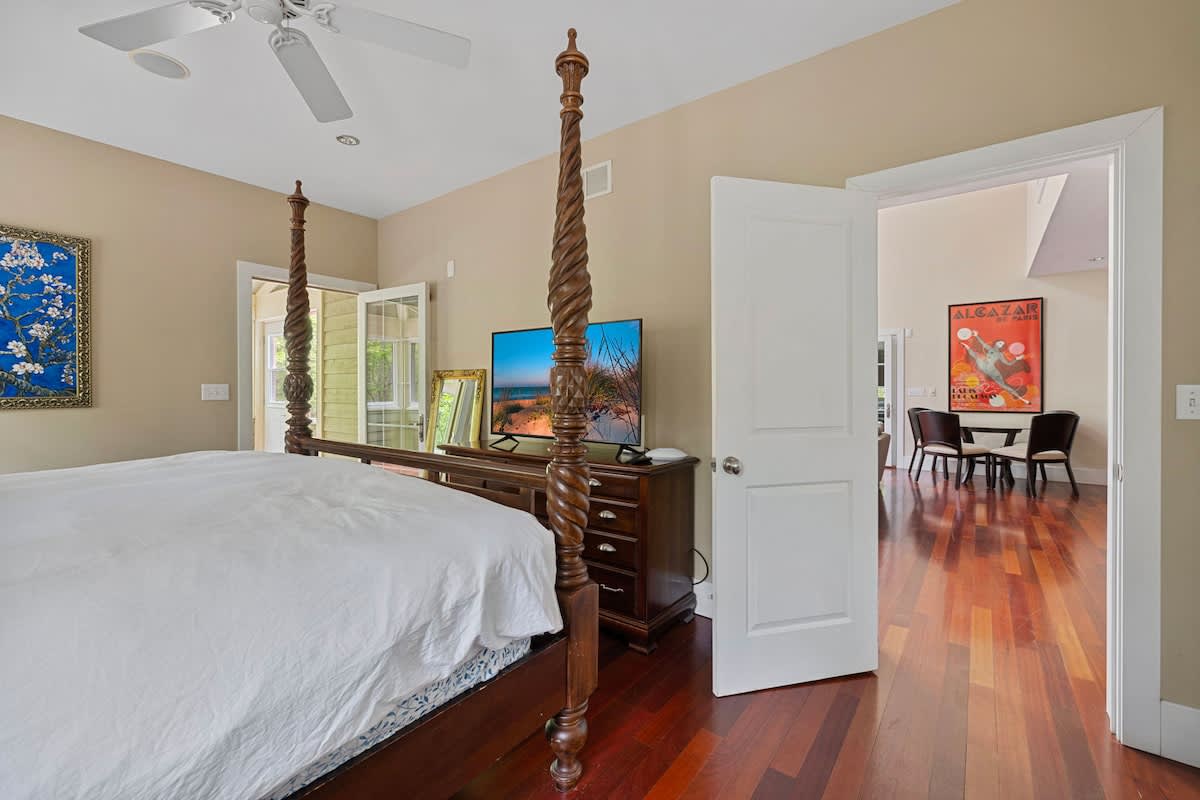Exquisite wood-carved 4-poster bed. Flat-screen TV. Easy outdoor access. Check.