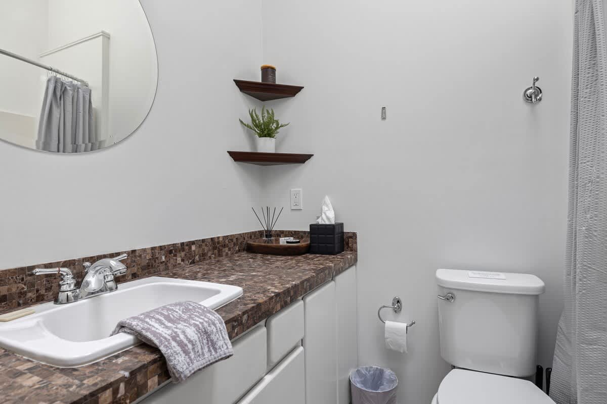 The Master Bathroom is smartly designed with a wide, beautifully tiled vanity.