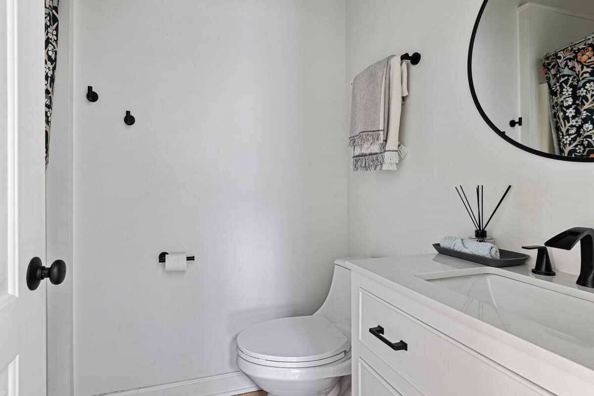 The second bathroom is accentuated by a stone-top vanity and deluxe fixtures.