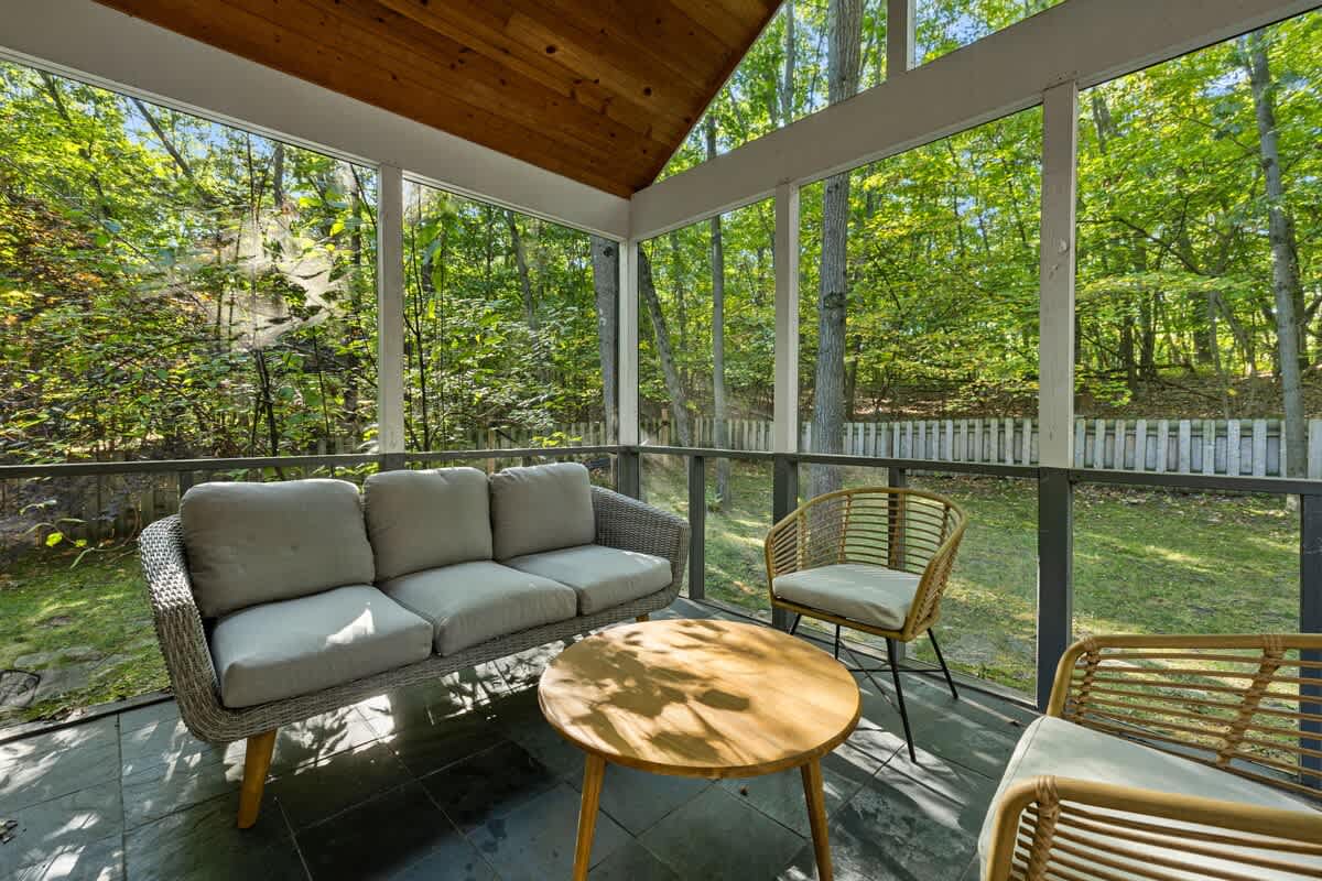 The screened-in porch features outstanding woodland views, including at sunset.