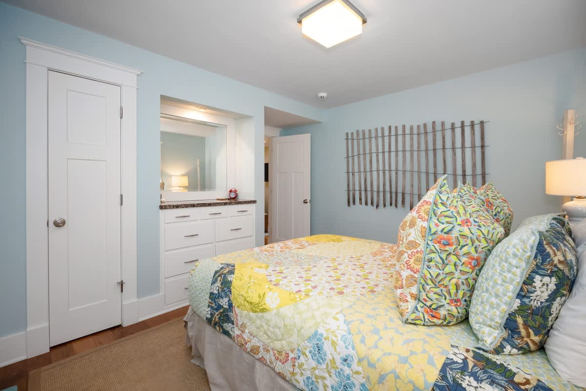 This cozy bedroom shares access to a sitting room that has a comfy sofa-bed.