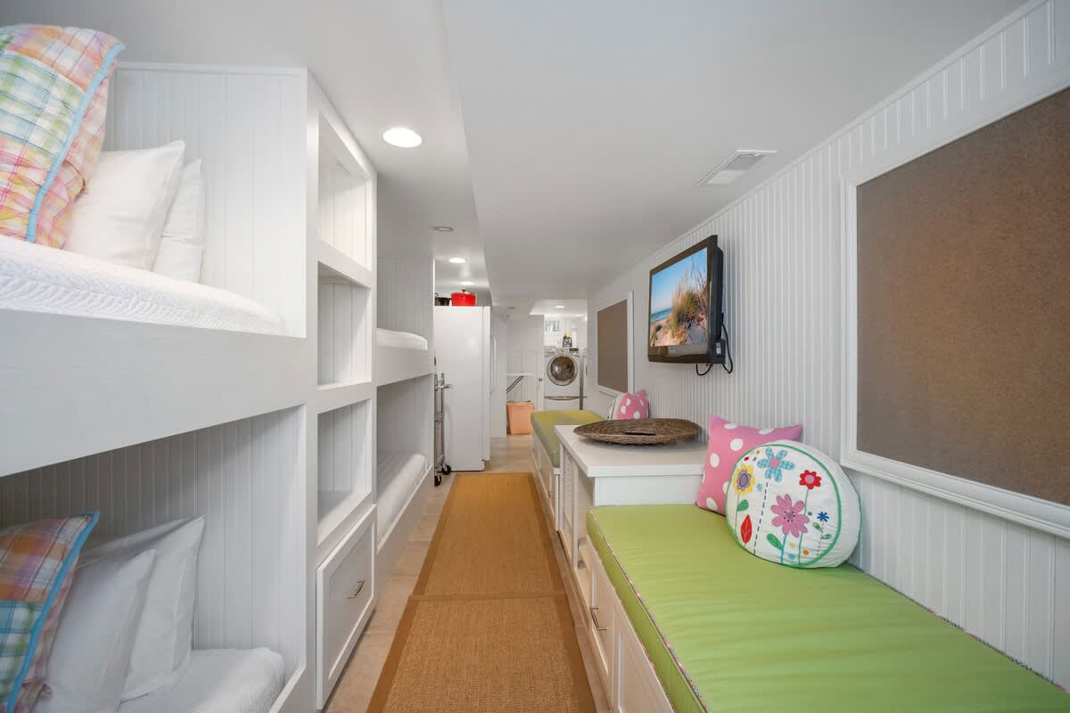 Two sets of bunk beds and a flat-screen TV on the lower level. Ooh-la-la!