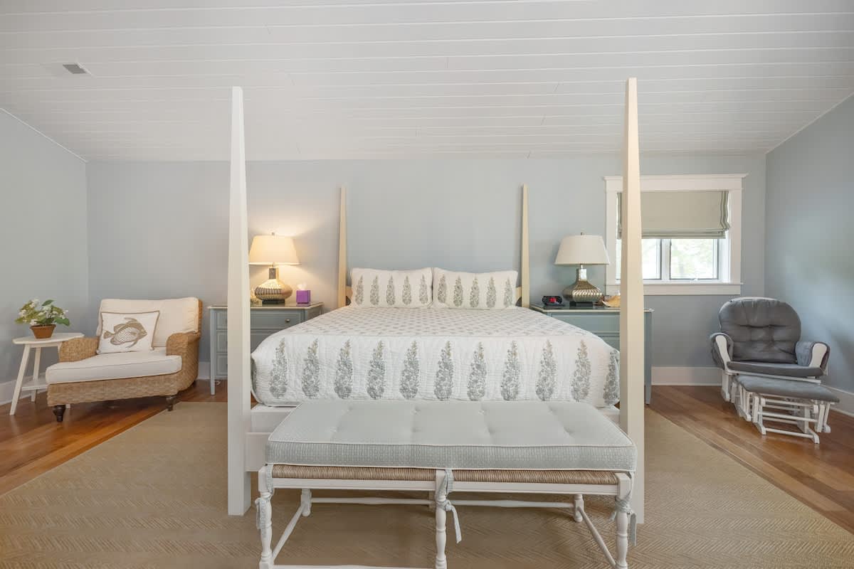 Primary bedroom is on the upper level & has a king-size bed.