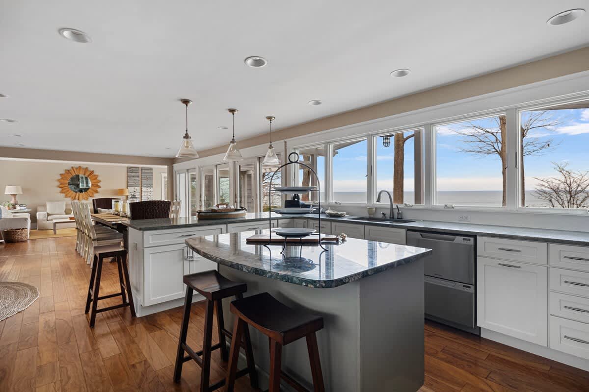 The chic open design joins the sunroom, living room, dining room and kitchen.