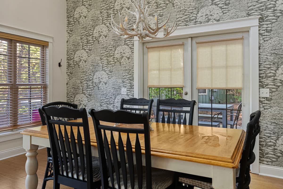 The dining table seats six; the screened-in porch has plenty more places to sit.