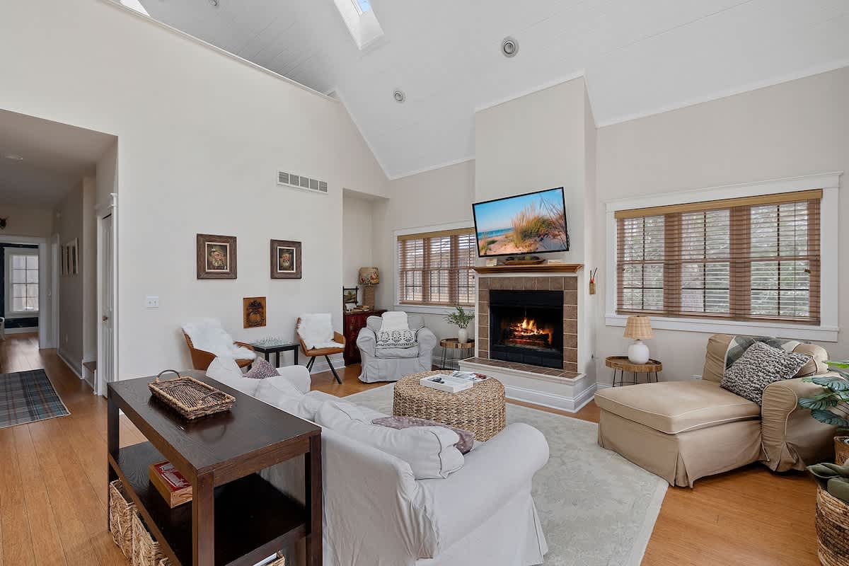 Seating options galore in the living room. A fire, glass of wine, a movie. Boom.