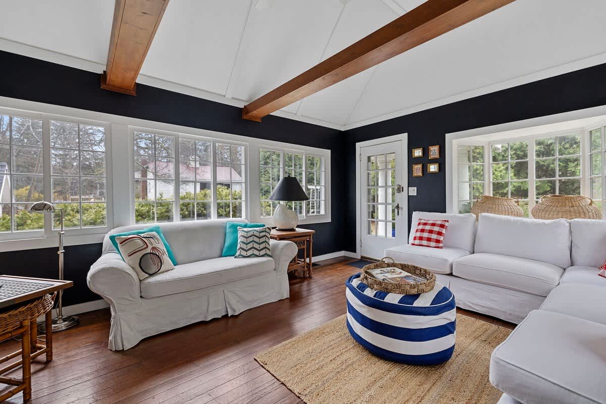 Wraparound French windows feed light + beauty into this popular gathering spot.