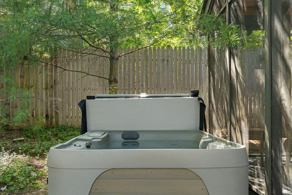 Step into serenity—your secluded hot tub sanctuary awaits, surrounded by nature's embrace. Perfect for melting away the stress of the day.