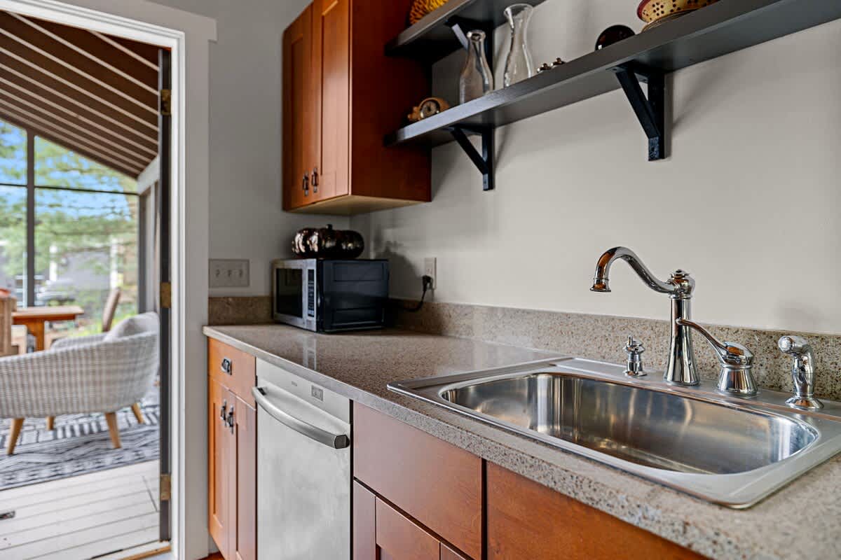 Just off the kitchen is a way-nicely furnished 3-Season porch and dining table.