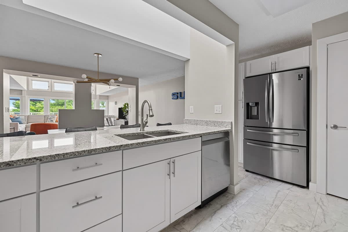 Whipping up culinary magic in this sleek, modern kitchen!