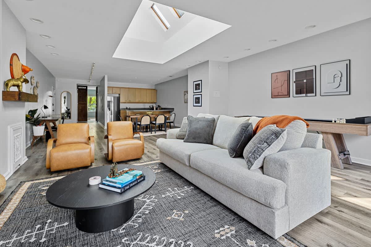 Basking in the natural glow of the skylight, cozied up on this comfy couch. Perfect spot for some quality 'me' time!