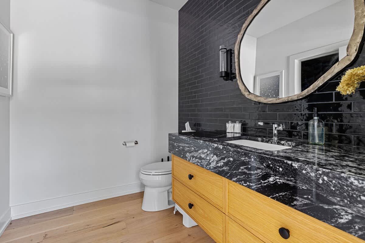 Mixing modern monochrome with rustic wood for the perfect bathroom blend.