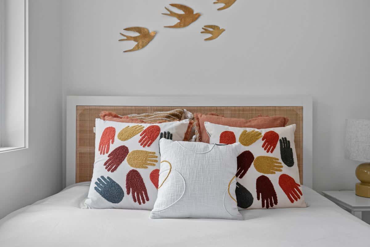 Sink into comfort and relaxation with this inviting bed, surrounded by plush pillows.