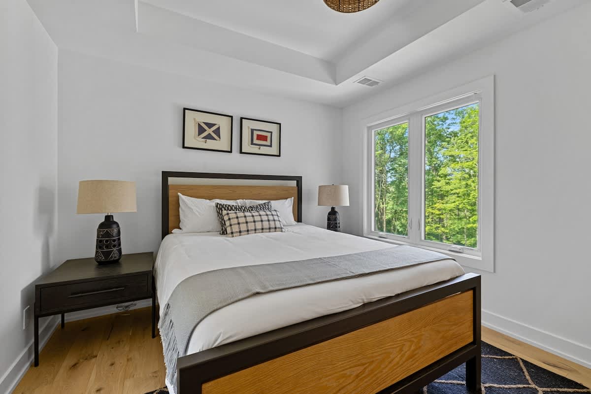 Step into my personal paradise with a cozy bed, nightstand, and window to unwind and recharge.