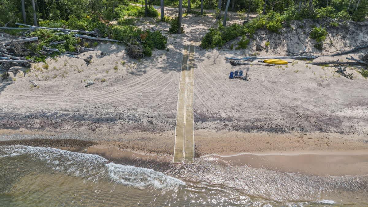 Adventure awaits down this sandy path.