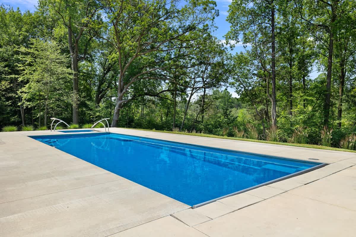 Relaxing by the pool surrounded by nature's beauty.