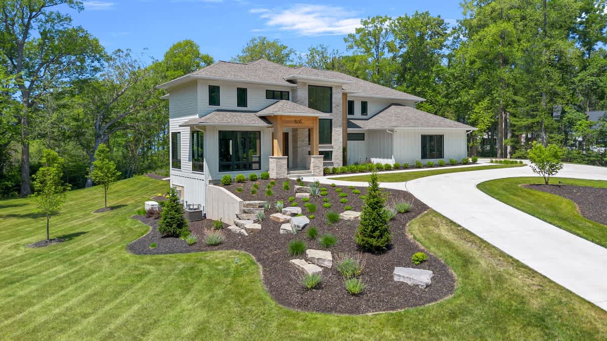 Nestled amidst lush landscaping and towering trees, this large abode is the epitome of tranquility.